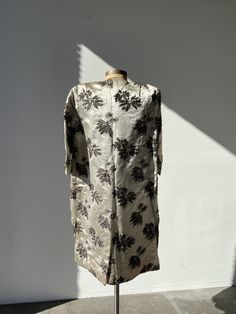 This Haute Couture International ensemble is composed of a silvery champagne tone embellished silk with a beaded floral motif. Dress fits close to the Body with a sweetheart neckline and a back zipper closure. The coat features center fabric covered button closures. In vintage condition with a stain on side of dress and coat ( subtle but there). See all pictures before purchasing Era 60s Brand Haute couture int'l made in Hong Kong Size small *This brand is rare and sought after- the only other i Elegant Evening Dress In Raw Silk, Elegant Raw Silk Evening Dress, Elegant Evening Raw Silk Dress, Festive Raw Silk Evening Dresses, Elegant Brocade Dress With Sequins, Elegant Party Dress In Raw Silk, Embellished Fitted Raw Silk Dress, Fitted Embellished Raw Silk Dress, Fitted Brocade Dresses With Sequins