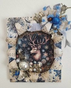 an altered photograph of a deer surrounded by christmas decorations and ornaments on a white wall