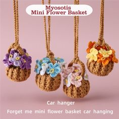 three small crocheted baskets with flowers hanging from the top and bottom, in front of a pink background