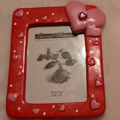 a red frame with hearts and flowers on it