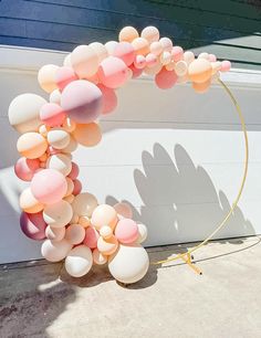 an arch made out of balloons in front of a garage