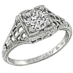 an antique style diamond ring with filigrees