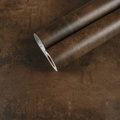 a pair of scissors sitting on top of a brown surface