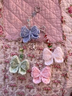 several pieces of crocheted fabric are arranged together on a quilted surface with flowers and hearts