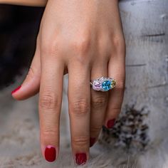 a close up of a person's hand with a ring on it