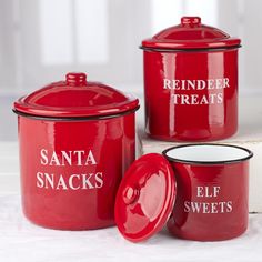 three red canisters with santa snacks written on them