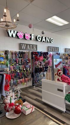 the inside of a clothing store with clothes on display and stuffed animals hanging from the ceiling