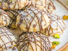 a white plate topped with pastries covered in chocolate