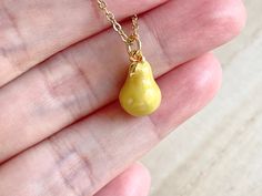 This dainty pear necklace is made of the followings: (1) gold plated green epoxy pear charm (14 x 8.5 mm) (2) gold plated or 14KGF chain and findings ✏️ Please choose the length of the chain (the length includes clasp and findings). ❣️ If you are unsure about which length to choose , please leave me a note to request an extension chain to be added to the chain at check out. 🍐EARRINGS 🍐 Hooks -> https://www.etsy.com/listing/919575709 🍐OTHER STYLE 🍐 YELLOW PEAR → https://www.etsy.com/listin Handmade Pear-shaped Gold Necklace, Yellow Teardrop Necklace For Gifts, Gold Pear-shaped Drop Necklace For Gift, Pear-shaped Yellow Necklace For Gift, Handmade Pear-shaped Necklace For Gift, Handmade Pear-shaped Necklace Gift, Pear Jewelry, Food Necklace, Fruit Necklace