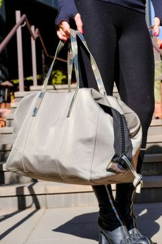 This convertible bag is the perfect lightweight solution for days and weekends when you need to carry it all but don’t want to be weighed down. Adjustable side flaps allow the bag to be pulled in for tote-style day wear or fully extended for weekender duffle-style functionality. IN TRANSIT can be comfortably carried by either the top handle or a strap can be added for hands-free wear. Dimensions: 15” wide (extended to 18”), 12 1.2” long, 9” deep Made in ItalyElevated Nylon with Luxury Leather Tr Jogger Shorts Women, Shinola Watch, Convertible Bags, Blazer Shirt, Jogger Shorts, Hats For Sale, Jewelry Bags, Convertible, Camo