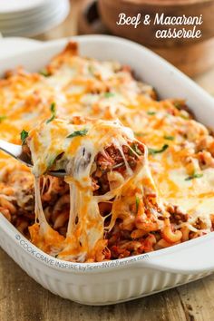 a casserole dish with beef and macaroni being lifted from the casserole