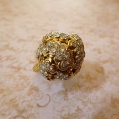 "I am very hesitant to part with this BEAUTIFUL & EXQUISITE Liberty House Of Hawaii Masterpiece, but alas, my loss is your gain This STUNNING & VERY RARE Size 8 Diamond Cluster Cauliflower Cocktail Ring - Solid 18K Gold - With 86 Full Cut Brilliant Diamond Stones - Rare Vintage Liberty House Hawaii Example - Circa 1970's, comes from the Estate of my late Grandmother who resided on the island of Oahu in Hawaii.   This SHOW-STOPPING piece features a profusion of diamond clusters that form into a s Luxury Gold Flower Cluster Ring, Luxury Vintage Gold Cluster Ring, Luxury Vintage Hallmarked Cluster Ring, House Hawaii, Luxury Antique Hallmarked Cluster Ring, Luxury Antique Multi-stone Cluster Ring, Liberty House, Hawaii Jewelry, Head Of Cauliflower