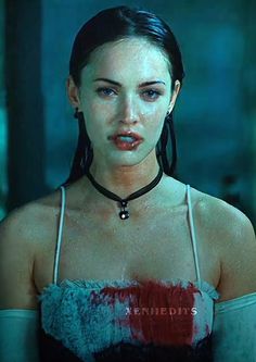 a woman wearing a choker with blood all over her chest and neck, looking at the camera