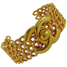 CHANEL vintage gold toned cuff bracelet featuring four rows of rigid chains and a large iconic CC turnlock at center. Fall/Winter 1997 collection. Marked CHANEL 97 A Made in France. Indicative measurements : inner circumference approx. 19.16 cm (7.54 inches) / width approx. 2.2 cm (0.87 inch) / wrist opening approx. 3.6 cm (1.42 inches). JEWELRY CONDITION CHART - New or never worn : item is in pristine condition with no noticeable imperfections - Excellent : item has been used and may have not m Luxury Vintage Chain Link Bracelets, Chanel Jewelry Earrings, Chanel Bracelet, Diamond Cuff Bracelet, Vintage Cuff Bracelet, Gold Link Bracelet, Gold Bracelet Cuff, Chanel Vintage, Chanel Jewelry