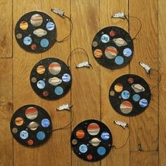 the solar system is made out of black plates with different planets painted on them and string attached to each plate