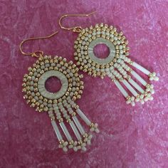 Small Hoop Dangle Earrings created cream and gold metallic seed beads. Each bead is individually and expertly woven to make these beautiful earrings. The french hook earwires and findings are 14kt gold plated. These very lightweight earrings measure 2 inches total. The hoops are 1 inches. Gorgeous for any occassion and super chic for a night on the town. All items are handmade and shipped promptly. Please allow extra time when ordering multiple items. Please see more items from Work of Heart at Gold Beaded Earrings With Spacer Beads, Beige Drop Earrings With Ear Wire, Nickel-free Cream Dangle Jewelry, Cream Dangle Earrings Nickel Free, Beige Dangle Jewelry With Ear Wire, Gold Round Beaded Earrings With Spacer Beads, Gold Teardrop Earrings With Spacer Beads, Nickel Free Cream Dangle Earrings, Bohemian Cream Jewelry With Ear Wire