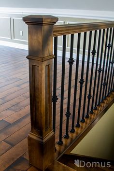 an empty room with wooden floors and railings