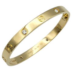 The inner circumference of this bracelet measures 6.38 inches and will comfortably fit up to a 6.25 inch wrist. This stunning Cartier Love Bracelet is an iconic piece crafted in 18 karat yellow gold and adorned with sparkling diamonds. This exquisite bracelet features the timeless screw motif, symbolizing enduring love and commitment, enhanced by the brilliance of meticulously set diamonds. The luxurious yellow gold setting perfectly complements the dazzling diamonds, creating a piece that exude Gold Jewelry Cartier, Gold Luxury Bracelet, Cartier Gold Bracelet, Gold Cartier Bracelet, Good Bracelet, Cartier Bracelets, Cartier Love Bangle, Cartier Bangle, Modern Bangle