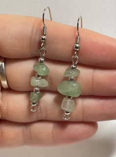 These unique earrings feature green aventurine with silver accent beads. Green Aventurine Dangle Earrings, Green Aventurine Drop Earrings, Green Jade Earrings For Healing, Green Beaded Dangle Earrings With Natural Stones, Adjustable Green Beaded Earrings With Natural Stones, Silver Aventurine Dangle Jewelry, Earthy Jewelry, Ear Rings, Silver Accents