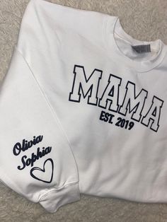 Our mama sweatshirt is the perfect gift for all moms! The embossed style lettering will leave mama feeling cozy yet chic every day. Personalize the left sleeve with the names of the mother's children and/or loved ones to make it even more special. All items are custom made to order with love and care . * Orders are typically processed and shipped within 3-5 business days. This may change during the holiday season, please view current posted processing times! * Need it by a specific date? Please Custom Mom Gifts, Family Matching White Sweatshirt With Letter Embroidery, White Family Matching Sweatshirt With Letter Embroidery, White Tops With Letter Embroidery For Mother's Day, Mother's Day Crew Neck Sweatshirt With Lettering, Mother's Day Lettering Crew Neck Sweatshirt, White Sweatshirt For Mother's Day, Christmas Gift Mom, Mom Sweater