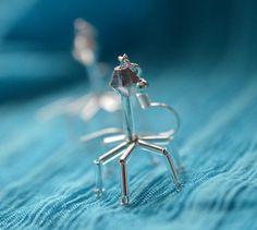 a small silver object sitting on top of a blue blanket