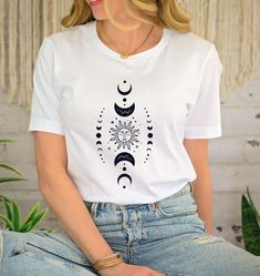 Mystic Moon And Sun Shirt, Mystical Moon Phase Shirt, Moon Phase Tshirt, Boho Vintage Moon Shirt, Celestial Moon Shirt, Spiritual Shirt This design is suitable for dark colors. --How To Order-- 1-) Please, Check and Review all Photos. 2-) Choose Your T-Shirt Size and Model From the "Size" Menu. 3-) Choose Your T-Shirt Color from "Primary Color" Menu. 4-)Choose the quantity as much as you want. 5-) Click ADD TO CART. You can go back to add more product color for your family members anytime you want, or you can complete the checkout process. 6-) Please click the "Proceed to Check Out" button 7-) Finally, Processing time is 1-3 days. Shipping time is based on the shipping type you'll select at checkout. -When you check out, you can add a note to seller for any request. -The shirts are very hi Cresent Moon Shirt, Casual Summer T-shirt With Sun And Moon Design, Mystical Moon Shirt, Moon Phases Shirt, Casual Cotton T-shirt With Moon Print, Bohemian Cotton T-shirt With Moon Print, Mystic Moon, Spiritual Shirts, Vintage Moon