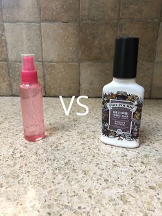 two bottles of hand sanitizers sitting on a counter next to each other, one pink and the other white