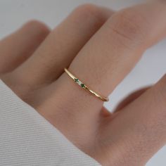 Minimalist style emerald ring is great for a dainty look and great for pairing with other rings!  - - - D E T A I L S - - - * Made of 925 Sterling Silver * Available in 14k Gold or Rhodium Plated * We use a THICK, DURABLE plating - for a piece that will last you years to come! * VERY HIGH QUALITY * Available in sizes 4-10 * Ring Width: 1.4mm * Features 3 small Cubic Zirconia Stones - made of the highest grade for an authentic diamond & emerald look! * Also available in Sapphire, Ruby and Diamond colored stones Diamond https://www.etsy.com/listing/654125758/dainty-ring-gold-minimalist-ring?click_key=d3db711020a80a7b87c274e916d1b52c5c1a78cb%3A654125758&click_sum=69d6f74b&ref=shop_home_active_7&pro=1&sts=1 Ruby https://www.etsy.com/listing/1382697466/ruby-ring-minimalist-ring-birthstone?click Small Emerald Ring, 3 Stone Diamond Ring, Smaragd Ring, Gold Mangalsutra, Mangalsutra Designs, Zierlicher Ring, 3 Stone Rings, Ringe Gold, Rings Rings