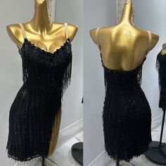 two mannequins dressed in black and gold with sequins on them