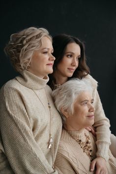 two older women and one younger woman are posing for the camera