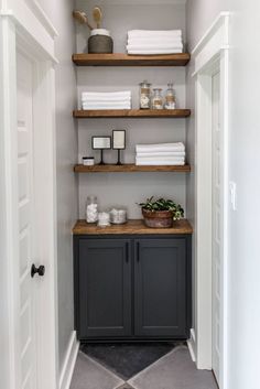 the shelves in this bathroom are filled with white towels and other things to use for storage