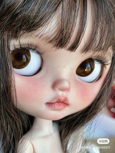 a close up of a doll with brown eyes