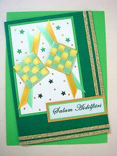 a green and gold greeting card with stars on the front, two squares in the middle