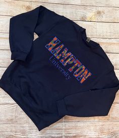 Embroidered Kente Hampton University Sweatshirt  University in Times New Roman  Blue stitching  Unisex sizing so ladies size appropriately  2 week turnaround prior to shipping Blue Embroidered T-shirt For Fall, White Cotton University Logo Sweatshirt, Hampton University Apparel, Queens University Kingston, University Logo Crew Neck T-shirt, Bethune Cookman University, College Sweater, Hampton University, University Outfit