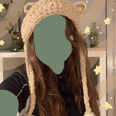 a woman wearing a crocheted bear hat