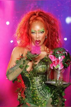 a woman with red hair and makeup holding a vase