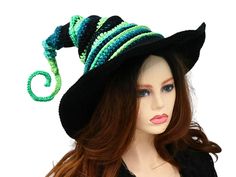 Ready for the Renfaire, a festival, cosplay, a pagan celebration, your table centerpiece, or just plain fun, this witch or wizard hat is firmly structured but soft to wear. You can shape this hat just about any way you like because both the tip and the brim are wired. I crocheted this in a fun blend of greens and black, with a solid black brim.  The tip can be shaped to curl or spiral and the stacked layers allow for fun curves or straight up. You can shape the brim to slant over your face, curve up on one side, or wear it flat. When you're not wearing it, you can toss it on your table for a great conversational centerpiece, or hang it on a hook by the door! Folds flat for travel. -This soft witchy hat has some stretch so it will fit between 21" to 23.5" head circumference. -3.5" brim How Witchy Winter Party Costume Hats And Headpieces, Witchy Winter Costume Hat, Witchy Winter Hats For Party, Adjustable Green Costume Hats And Headpieces, Whimsical Black Hat For Festival, Adjustable Christmas Costume Hats, Themed Black Costume Hats And Headpieces For Festivals, Adjustable Hats For Themed Events At Carnival, Adjustable Hats For Themed Events And Carnival