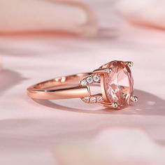 Adorn your finger with the morganite ring and experience the epitome of luxury. At its center gleams an exquisite oval-cut morganite, radiating with a captivating allure. Framing this breathtaking stone are intricate hollow designs adorned with shimmering white stones, creating a harmonious blend of modern elegance and timeless beauty. The delicate hollow deisgn on either side of the main stone add a touch of ethereal charm, allowing light to dance through the ring, accentuating its brilliance. The white stones delicately set within the metalwork enhance the ring's luminosity, creating a mesmerizing display of sparkle and shine.This enchanting piece is a testament to the wearer's refined taste and individuality. Its unique design effortlessly combines contemporary aesthetics with a hint of Oval Pink Morganite Diamond Ring, Luxury Pink Oval Topaz Ring, Rose Gold Morganite Topaz Ring, Elegant Oval Rose Gold Topaz Ring, Elegant Rose Gold Oval Topaz Ring, Classic Oval Morganite Diamond Ring, Oval Pink Morganite Jewelry, Blush Oval Jewelry For Anniversary, Oval Blush Jewelry For Anniversary