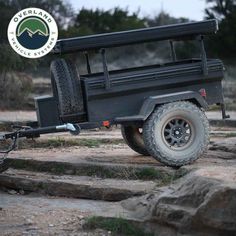 an off road utility trailer parked on some rocks