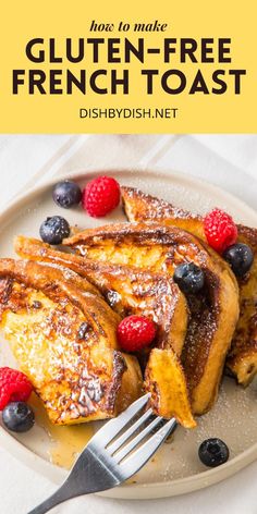 french toast on a plate with berries and powdered sugar, next to a fork