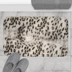 an animal print rug with slippers on the floor