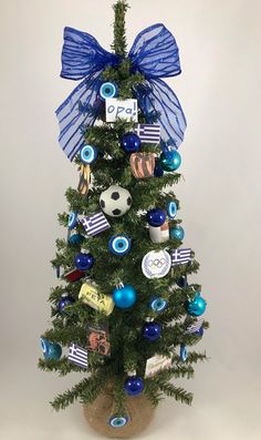 a small christmas tree with blue and white ornaments