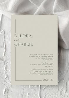 a white wedding card with the words alora and charlie on it