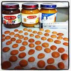 three jars of peanut butter sitting on top of a table next to a measuring tape