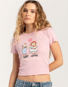 Raggedy Ann & Andy Baby Tee. Large Graphic Screened On Front. Ribbed Crew Neckline. Short Sleeve. Shrunken Fit. 100% Cotton. Machine Wash. Imported. Model Is Wearing A Size Small. Model Measurements:height: 5'7" Bust: 29"waist: 22"hips: 34.5" Sweet Fitted Tops For Spring, Playful Fitted Crew Neck Top, Fitted Cute Shirt With Graphic Print, Cute Fitted Shirt With Graphic Print, Fitted Shirt With Graphic Print In Cute Style, Fitted Sweet Top With Graphic Print, Fitted Playful Tops For Spring, Fitted Pink Top With Funny Print, Cute Fitted Tops With Funny Print