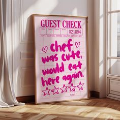 a pink poster with the words guest check written on it in front of a window