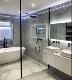 a bathroom with two sinks and a bathtub