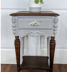 a small table with a potted plant on top