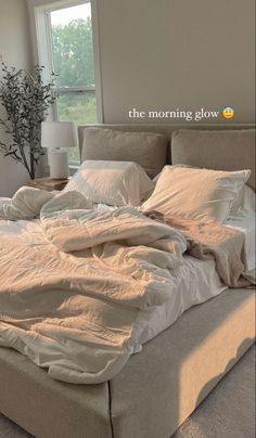 an unmade bed sitting in a bedroom next to a window with the words, the morning glow on it