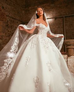 a woman in a white wedding dress and veil